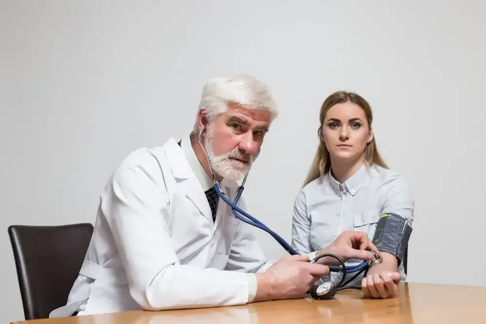 Cardiologist conducting a hypertension check and cardiovascular risk evaluation for a female patient