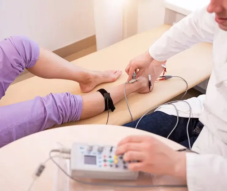 Vein doctor evaluating circulation and lower leg swelling at a vein clinic